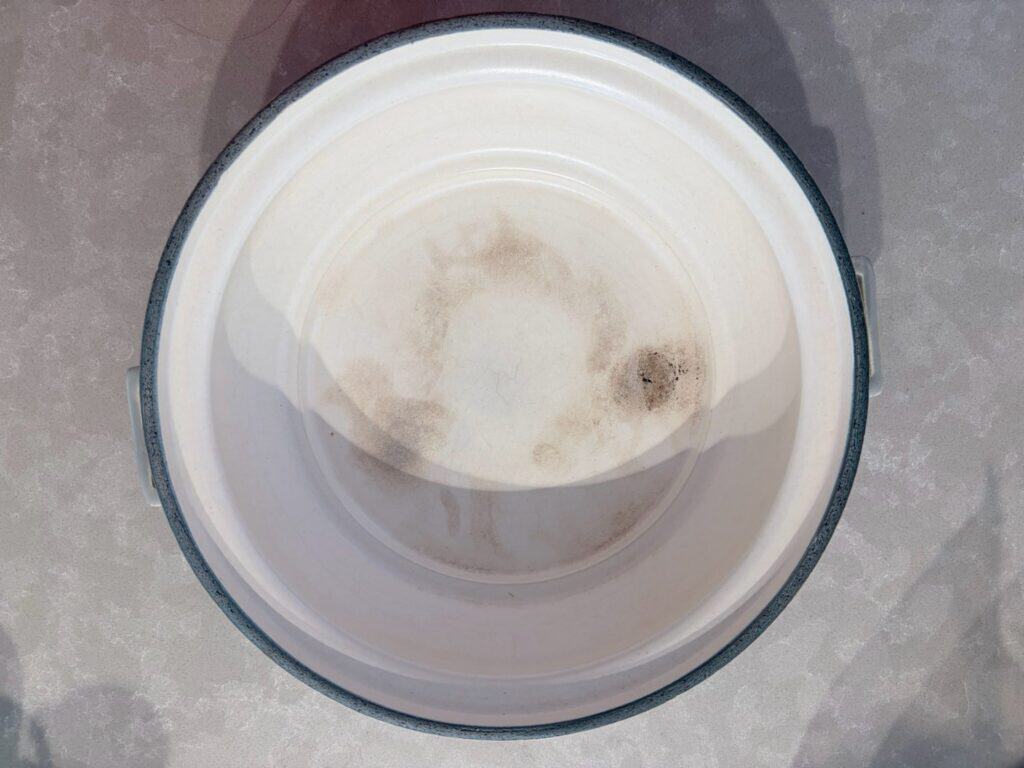 The glazed white interior of a donabe after two winters of use
