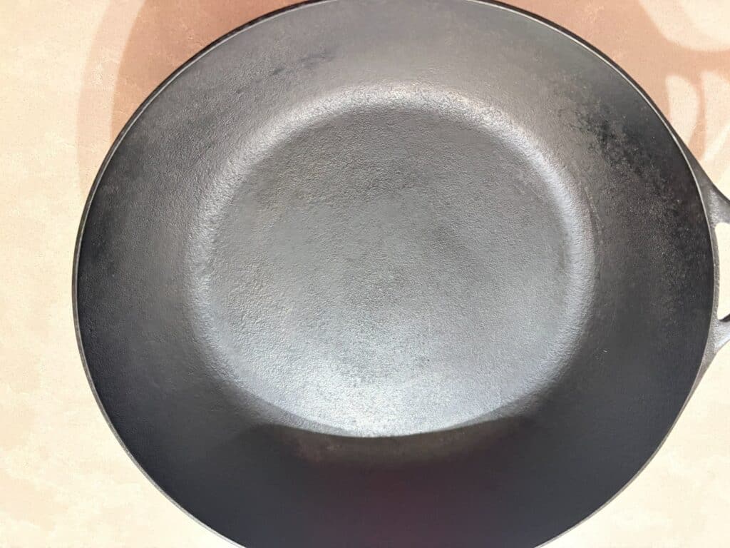 The surface of a japanese cast iron pan two years after scraping it back