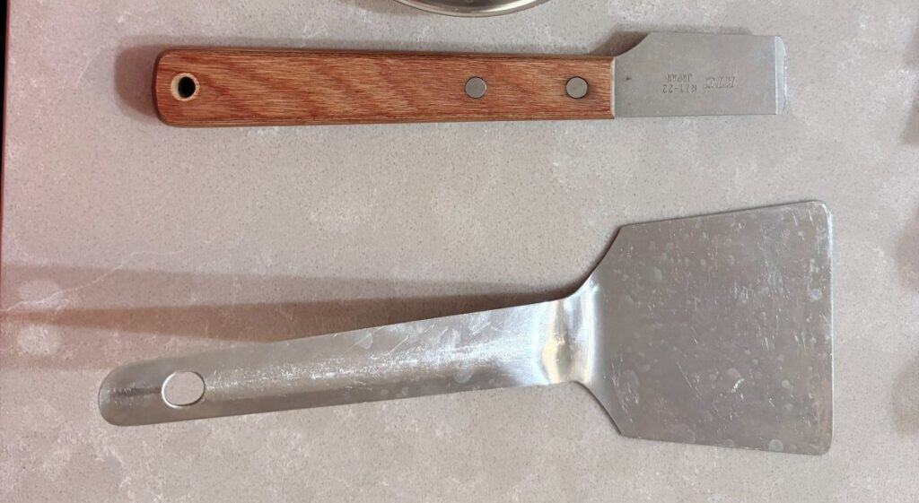 Two scrapers - the stiff one that worked on a japanese cast iron pan and the turner that did not
