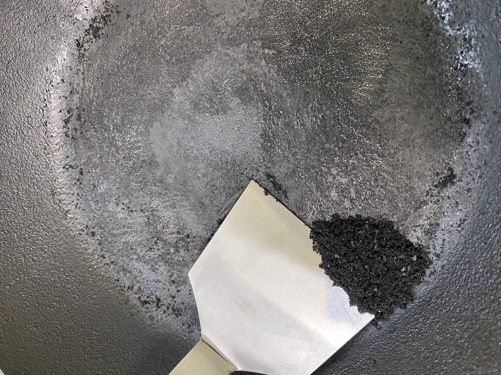 Carbon scraped off a japanese cast iron pan, piled on the scraper