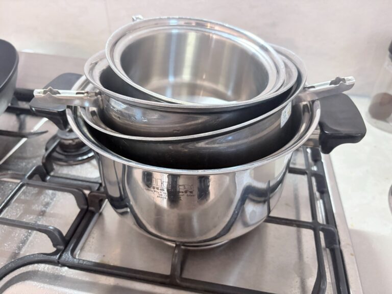 Donabe vs dutch oven: a six-piece stainless set nested with the handles removed